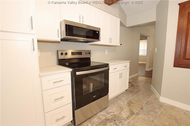 2111 21st St, Nitro, WV 25143 - kitchen featuring stainless steel appliances, light countertops, baseboards, and white cabinetry