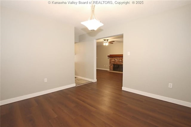 2111 21st St, Nitro, WV 25143 - spare room with a ceiling fan, wood finished floors, baseboards, and a brick fireplace