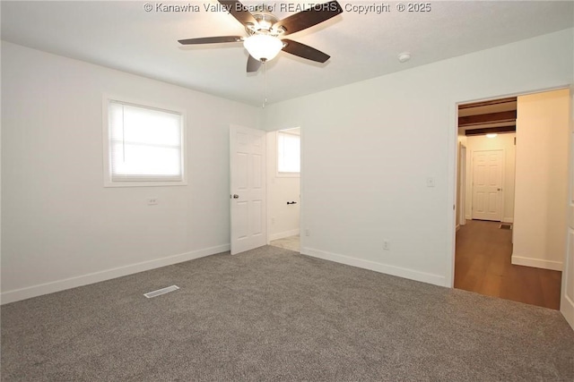 2111 21st St, Nitro, WV 25143 - unfurnished bedroom with multiple windows, carpet, and baseboards