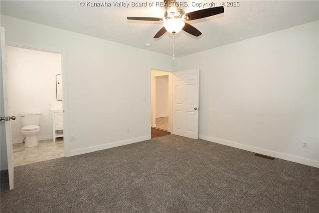 2111 21st St, Nitro, WV 25143 - unfurnished bedroom with carpet, connected bathroom, baseboards, and ceiling fan