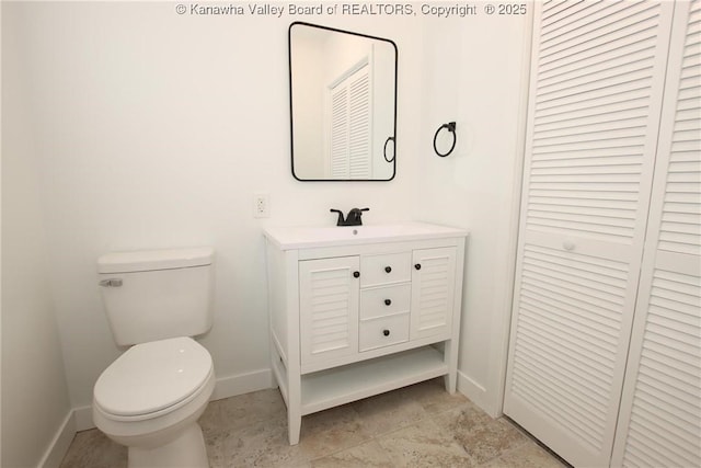 2111 21st St, Nitro, WV 25143 - bathroom featuring a closet, baseboards, toilet, and vanity