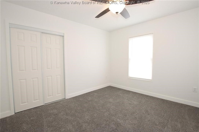 2111 21st St, Nitro, WV 25143 - unfurnished bedroom featuring dark colored carpet, baseboards, a closet, and ceiling fan