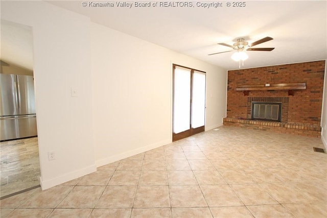 2111 21st St, Nitro, WV 25143 - unfurnished living room with ceiling fan, light tile patterned flooring, baseboards, and a brick fireplace