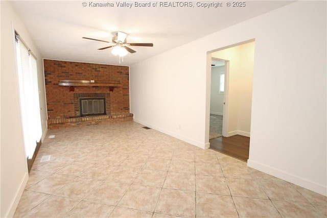 2111 21st St, Nitro, WV 25143 - unfurnished living room with ceiling fan, light tile patterned floors, a brick fireplace, and baseboards