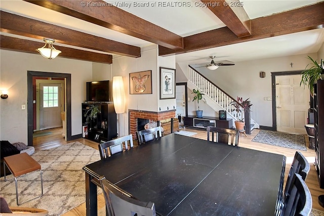 918 Greendale Dr, Charleston, WV 25302 - dining area featuring stairway, light wood-style flooring, beam ceiling, a fireplace, and ceiling fan