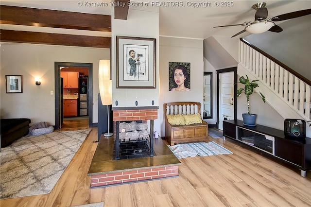 918 Greendale Dr, Charleston, WV 25302 - living room featuring a ceiling fan, wood finished floors, stairs, and a brick fireplace