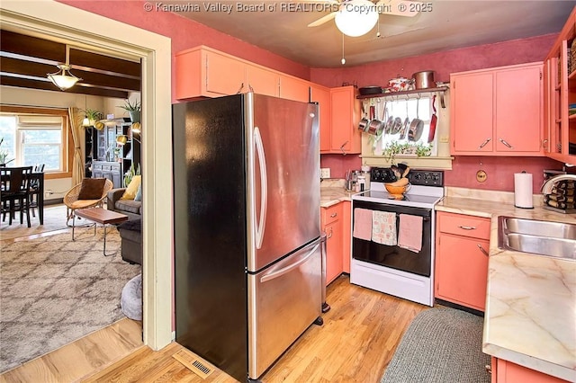 918 Greendale Dr, Charleston, WV 25302 - kitchen featuring freestanding refrigerator, electric stove, a sink, ceiling fan, and light countertops