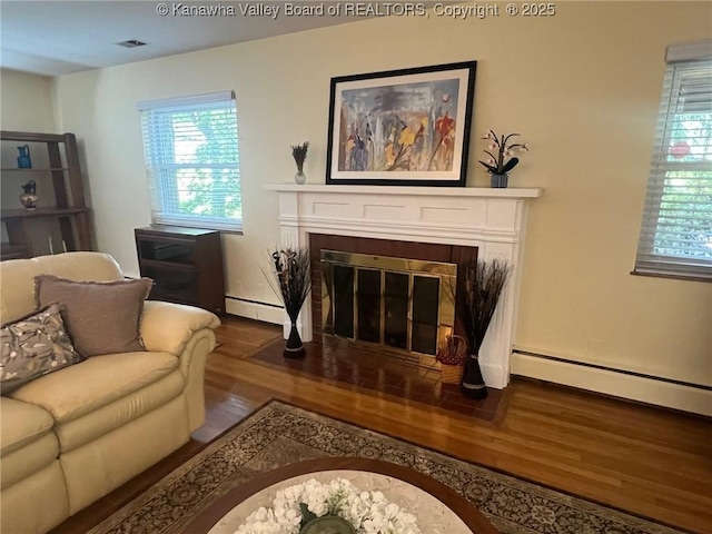 814 Skinner Dr, Saint Albans, WV 25177 - living room with wood finished floors, a fireplace with flush hearth, baseboard heating, and baseboards