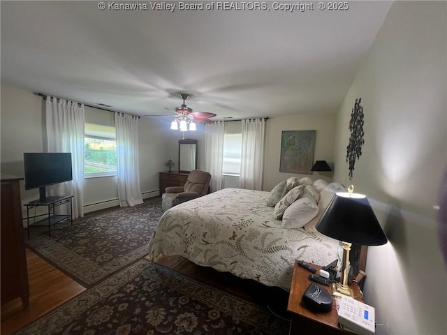 814 Skinner Dr, Saint Albans, WV 25177 - bedroom with a baseboard heating unit, wood finished floors, and a ceiling fan