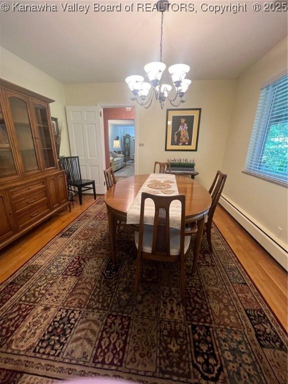 814 Skinner Dr, Saint Albans, WV 25177 - dining room with wood finished floors, a chandelier, and baseboard heating