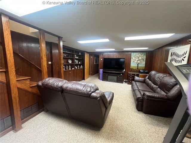 814 Skinner Dr, Saint Albans, WV 25177 - living area featuring wooden walls, light carpet, and stairway