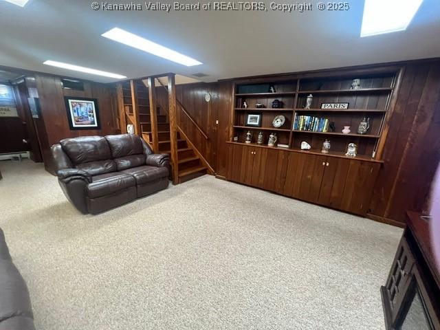 814 Skinner Dr, Saint Albans, WV 25177 - carpeted living room with stairs and wood walls