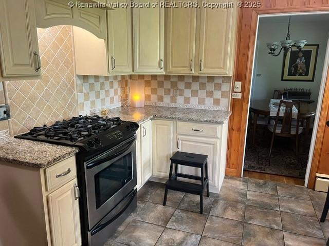 814 Skinner Dr, Saint Albans, WV 25177 - kitchen with stainless steel gas stove, decorative backsplash, light stone countertops, and cream cabinetry