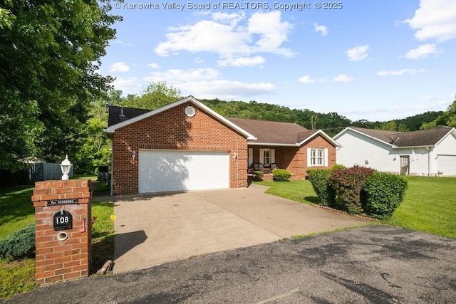 108 Lock Ln, Alum Creek, WV 25003 - view of front of home with brick siding, a front lawn, and an attached garage