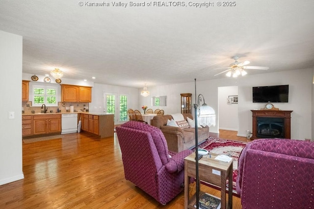 108 Lock Ln, Alum Creek, WV 25003 - living area featuring light wood-type flooring, a ceiling fan, plenty of natural light, and a fireplace
