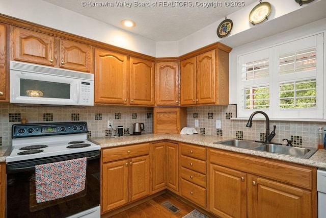 108 Lock Ln, Alum Creek, WV 25003 - kitchen with white appliances, a sink, dark wood-style flooring, light countertops, and brown cabinets