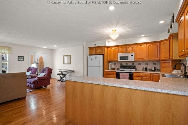 108 Lock Ln, Alum Creek, WV 25003 - kitchen featuring white appliances, a sink, a peninsula, a textured ceiling, and open floor plan