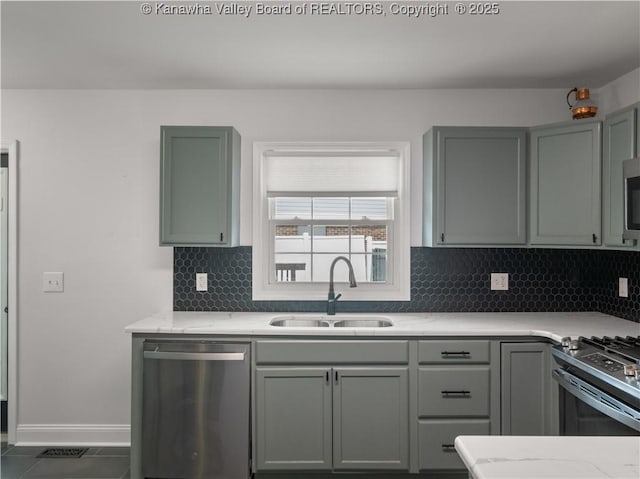 1300 Enslow Blvd, Huntington, WV 25701 - kitchen featuring appliances with stainless steel finishes, a sink, backsplash, and gray cabinetry