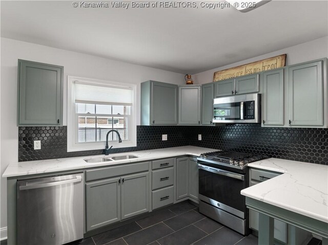 1300 Enslow Blvd, Huntington, WV 25701 - kitchen with stainless steel appliances, a sink, gray cabinetry, and light stone counters