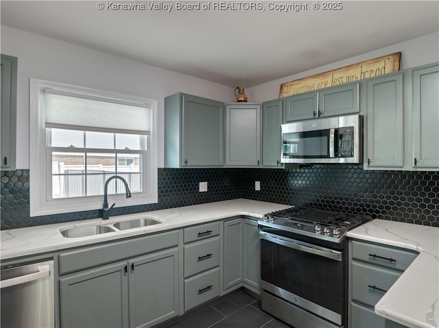 1300 Enslow Blvd, Huntington, WV 25701 - kitchen featuring appliances with stainless steel finishes, a sink, light stone counters, dark tile patterned flooring, and decorative backsplash