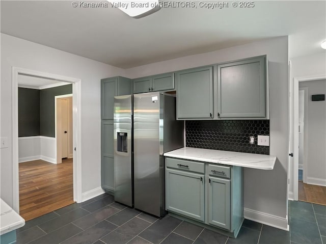 1300 Enslow Blvd, Huntington, WV 25701 - kitchen featuring stainless steel refrigerator with ice dispenser, baseboards, decorative backsplash, gray cabinets, and dark tile patterned flooring