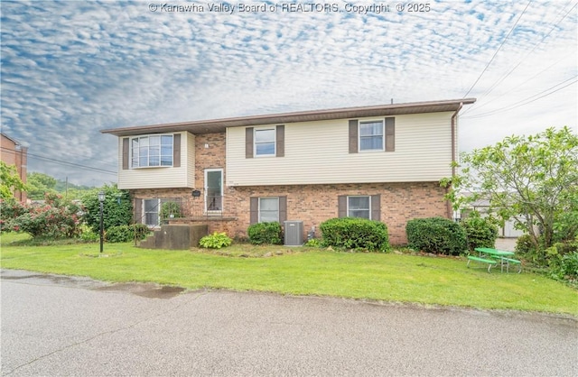400 13th St, Dunbar, WV 25064 - split foyer home with central air condition unit, brick siding, and a front lawn