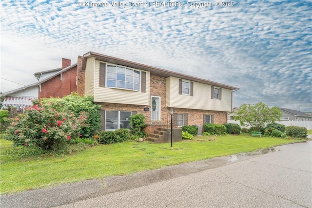400 13th St, Dunbar, WV 25064 - bi-level home with brick siding, a front yard, and a chimney