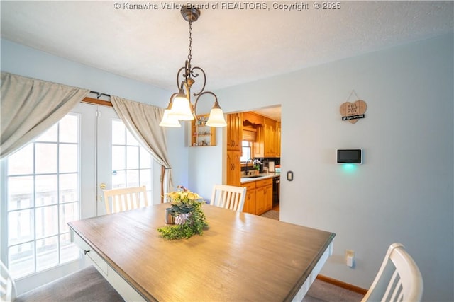 400 13th St, Dunbar, WV 25064 - dining space featuring baseboards and a chandelier