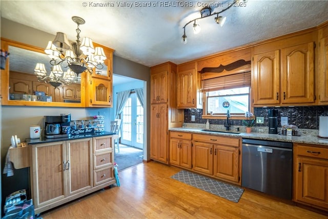 400 13th St, Dunbar, WV 25064 - kitchen featuring stainless steel dishwasher, a sink, light wood-style flooring, and plenty of natural light