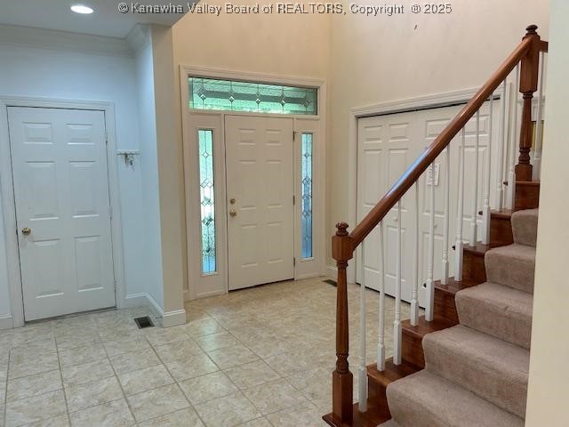 8 Dapplewood Rd, South Charleston, WV 25309 - entrance foyer with stairs, light tile patterned floors, baseboards, and a towering ceiling