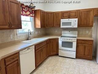 8 Dapplewood Rd, South Charleston, WV 25309 - kitchen with white appliances, a sink, brown cabinetry, backsplash, and light countertops