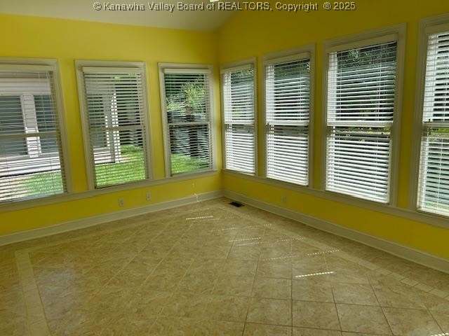 8 Dapplewood Rd, South Charleston, WV 25309 - unfurnished sunroom featuring healthy amount of natural light, baseboards, and tile patterned floors