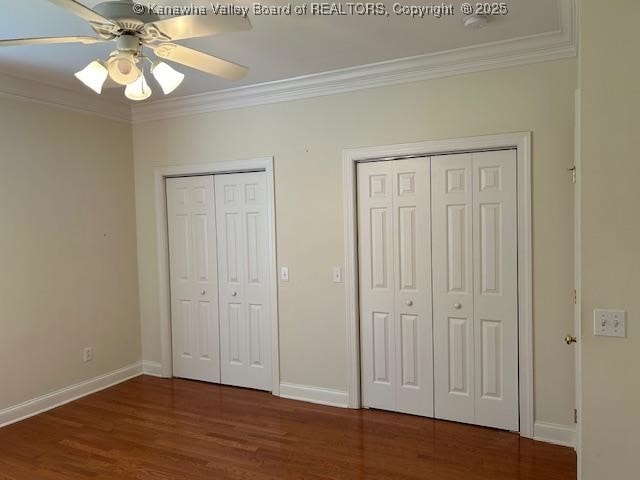 8 Dapplewood Rd, South Charleston, WV 25309 - unfurnished bedroom with multiple closets, crown molding, wood finished floors, baseboards, and ceiling fan