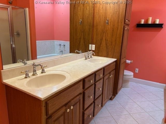 8 Dapplewood Rd, South Charleston, WV 25309 - full bath with a shower stall, double vanity, a garden tub, tile patterned flooring, and toilet