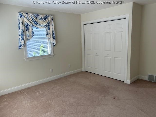 8 Dapplewood Rd, South Charleston, WV 25309 - unfurnished bedroom with carpet flooring, baseboards, and a closet