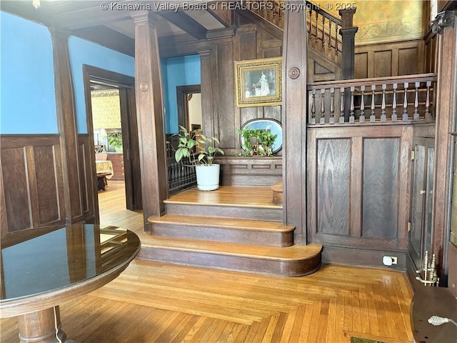 1565 Virginia St E, Charleston, WV 25311 - stairway featuring decorative columns, a wainscoted wall, and wooden walls