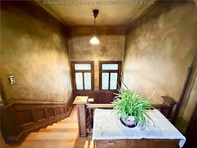 1565 Virginia St E, Charleston, WV 25311 - dining room featuring wood finished floors, stairs, ornamental molding, and a decorative wall