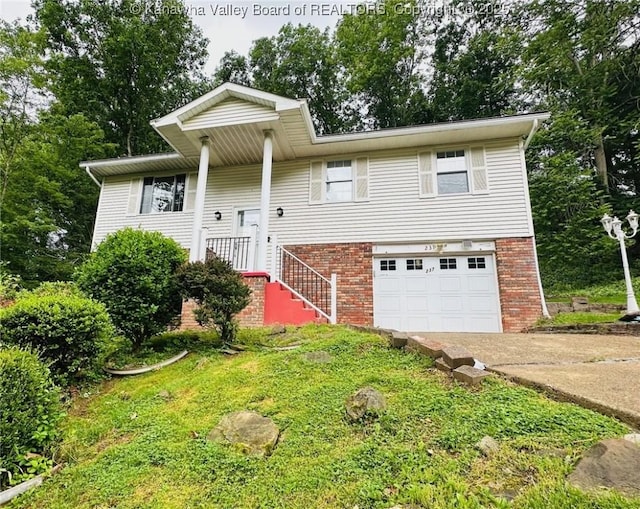 237 Pine Cir, Dunbar, WV 25064 - raised ranch featuring driveway, a garage, brick siding, and a front yard
