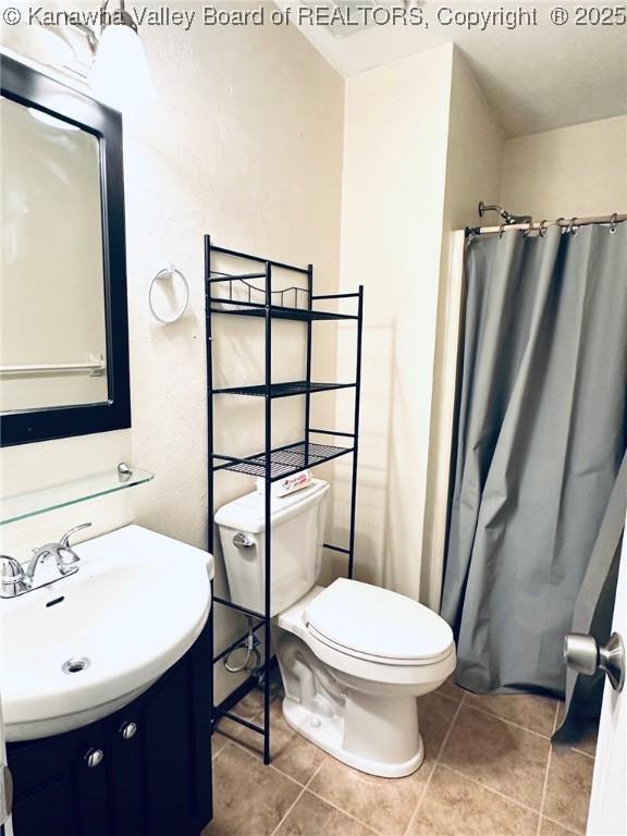 237 Pine Cir, Dunbar, WV 25064 - full bath with vanity, tile patterned flooring, toilet, and a shower with curtain