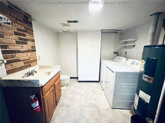 237 Pine Cir, Dunbar, WV 25064 - bathroom featuring electric water heater, separate washer and dryer, brick wall, toilet, and vanity