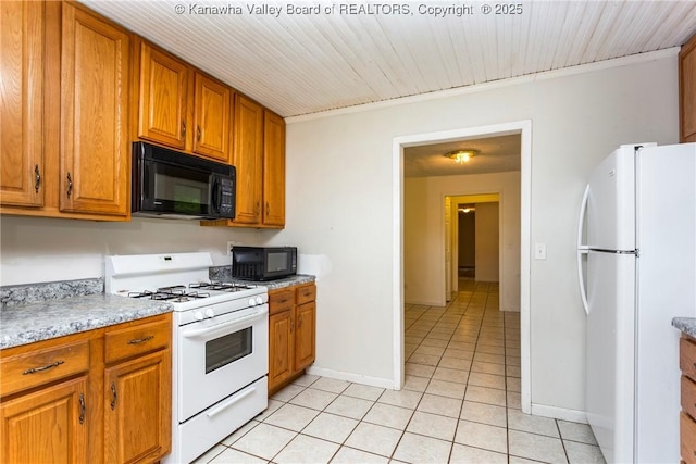 4096 Indian Creek Rd, Elkview, WV 25071 - kitchen with white appliances, light tile patterned floors, brown cabinetry, light countertops, and baseboards