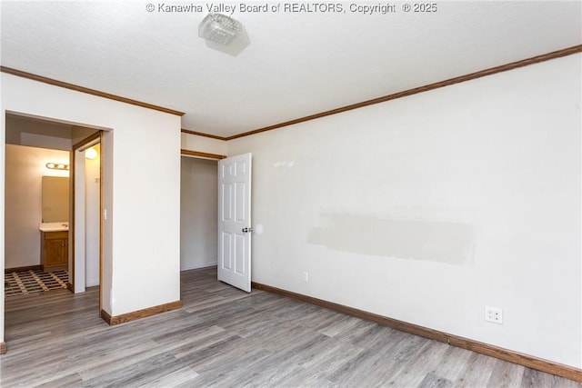4096 Indian Creek Rd, Elkview, WV 25071 - unfurnished bedroom featuring light wood-style floors, crown molding, baseboards, and a closet