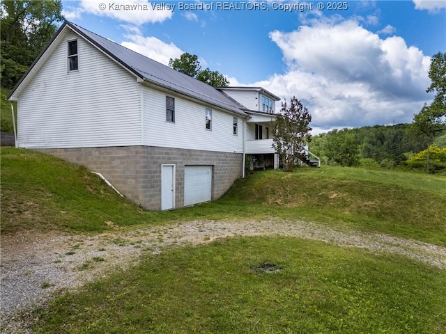 4096 Indian Creek Rd, Elkview, WV 25071 - view of side of property with a garage, driveway, metal roof, and a yard