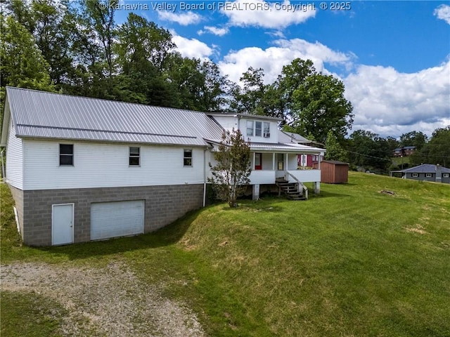 4096 Indian Creek Rd, Elkview, WV 25071 - back of property with driveway, a garage, a lawn, covered porch, and a shed