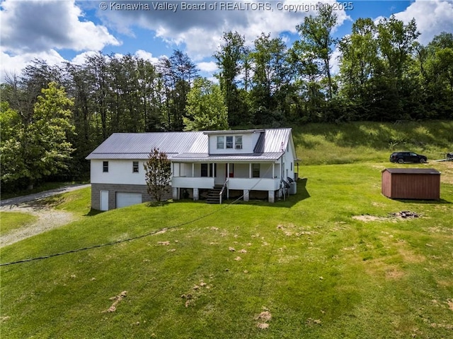 4096 Indian Creek Rd, Elkview, WV 25071 - view of front facade with a front lawn, metal roof, an attached garage, dirt driveway, and a porch