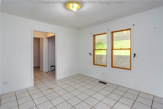 4096 Indian Creek Rd, Elkview, WV 25071 - spare room with a textured ceiling, baseboards, and light tile patterned floors
