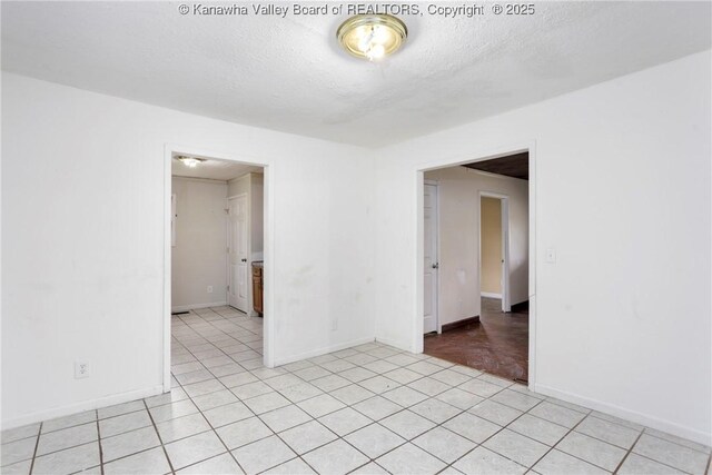 4096 Indian Creek Rd, Elkview, WV 25071 - empty room featuring a textured ceiling, baseboards, and light tile patterned flooring