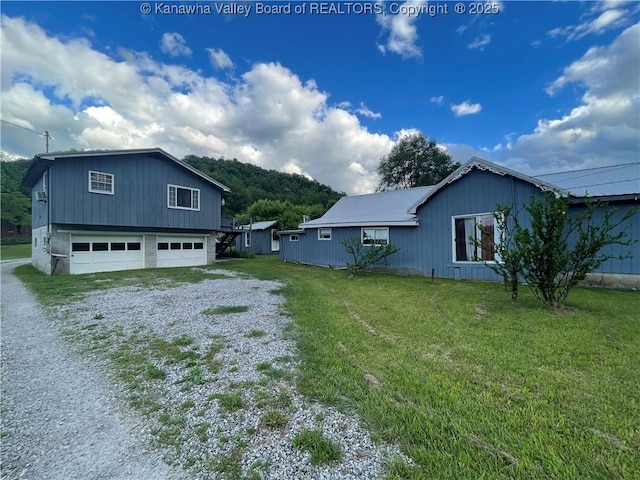 7966 Deepwater Mountain Rd, Kincaid, WV 25119 - view of property exterior with driveway, an attached garage, a yard, and metal roof
