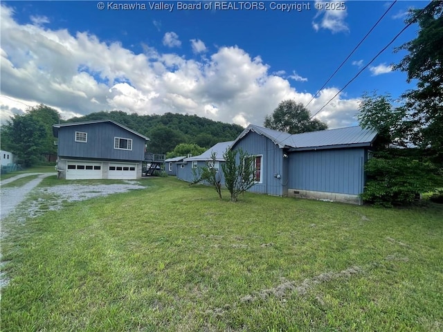 7966 Deepwater Mountain Rd, Kincaid, WV 25119 - view of grassy yard with driveway and a garage