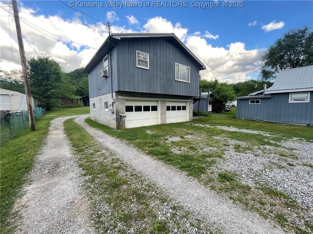 7966 Deepwater Mountain Rd, Kincaid, WV 25119 - view of property exterior with driveway, an attached garage, and cooling unit